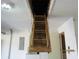 View of a wooden pull-down ladder for attic access, installed in the garage ceiling at 1155 Roan Ct, Kissimmee, FL 34759