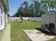 A spacious backyard offers a shed, a small palm tree, a white fence, and a well-manicured lawn at 1155 Roan Ct, Kissimmee, FL 34759