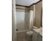Cozy bathroom featuring a shower/tub combo, commode, and vanity sink at 1155 Roan Ct, Kissimmee, FL 34759