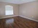 Bright bedroom with hardwood floors, large window and neutral paint at 1155 Roan Ct, Kissimmee, FL 34759