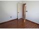 A bedroom featuring dark wood-look tile flooring and a partially open door at 1155 Roan Ct, Kissimmee, FL 34759