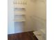Walk-in closet with wire and wood shelving and hardwood floors at 1155 Roan Ct, Kissimmee, FL 34759