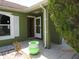 A nice green potted plant sits on the tiled front porch near the open front door at 1155 Roan Ct, Kissimmee, FL 34759