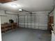 A clean, empty garage featuring a workbench on the left and an open garage door at 1155 Roan Ct, Kissimmee, FL 34759