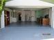 An open garage, revealing ample storage space, a water heater, a workbench, and well-lit interiors at 1155 Roan Ct, Kissimmee, FL 34759