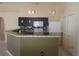 View of the kitchen featuring unique backsplash, countertop bar, and white appliances at 1155 Roan Ct, Kissimmee, FL 34759