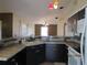 Cozy kitchen with dark cabinets, tile countertops and backsplash with stainless steel appliances at 1155 Roan Ct, Kissimmee, FL 34759