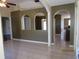 Open living room with tile floors, archways, and views of the hallway and other rooms at 1155 Roan Ct, Kissimmee, FL 34759