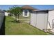 Side yard with storage shed and small tree at 1155 Roan Ct, Kissimmee, FL 34759