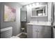 Cozy bathroom features a new vanity, updated fixtures, and a mirrored cabinet at 12 Robyn Ln, Haines City, FL 33844