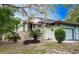 Charming single-story home featuring a stone facade and a well-manicured lawn in a peaceful, sunny neighborhood at 12 Robyn Ln, Haines City, FL 33844