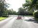 View of private community gate entrance and driveway at 12 Robyn Ln, Haines City, FL 33844
