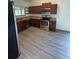 Modern kitchen featuring stainless steel appliances, wooden cabinets, and laminate flooring at 12 Robyn Ln, Haines City, FL 33844