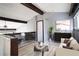 Bright living room boasts stylish modern decor, natural light, and vaulted ceilings with exposed beams at 12 Robyn Ln, Haines City, FL 33844