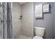 Modern bathroom features tile surround in shower, built-in shelf, and sleek fixtures at 12 Robyn Ln, Haines City, FL 33844