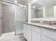 Bathroom featuring double sinks, granite counters, and a glass enclosed shower at 12035 Holystone St, Winter Garden, FL 34787
