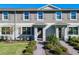 Charming townhome featuring a well-maintained front lawn and inviting entryway at 12035 Holystone St, Winter Garden, FL 34787