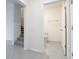 Hallway view with stairway and half bath featuring white tile flooring at 12035 Holystone St, Winter Garden, FL 34787