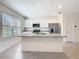 Bright kitchen features a large island, white cabinets, and stainless steel appliances at 12035 Holystone St, Winter Garden, FL 34787