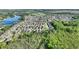This aerial view showcases the neighborhood's tranquil lake and verdant green spaces at 121 Fitzgerald Ln, Davenport, FL 33837