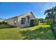 Backyard featuring a screened lanai, a well-maintained lawn, and mature trees at 121 Fitzgerald Ln, Davenport, FL 33837