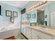 Bright bathroom offers double sinks, ample counter space, shower, and a soaking tub at 121 Fitzgerald Ln, Davenport, FL 33837