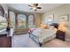 Comfortable bedroom with plush carpet, ceiling fan, and ample natural light at 121 Fitzgerald Ln, Davenport, FL 33837
