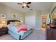 Comfortable bedroom with plush carpet, ceiling fan, and ample natural light at 121 Fitzgerald Ln, Davenport, FL 33837