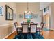 Formal dining room with hardwood floors, neutral paint colors, and decorative light fixture at 121 Fitzgerald Ln, Davenport, FL 33837