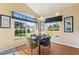 Charming dining area with lots of natural light, hardwood floors and views of the front yard at 121 Fitzgerald Ln, Davenport, FL 33837