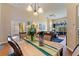 Spacious dining area showcasing hardwood floors, decorative lighting and runner, and views to the living room at 121 Fitzgerald Ln, Davenport, FL 33837