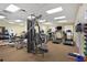 A spacious workout room with weight machines, treadmills, and televisions at 121 Fitzgerald Ln, Davenport, FL 33837