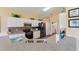 Well-maintained kitchen with tile backsplash, modern appliances, and views to the laundry room at 121 Fitzgerald Ln, Davenport, FL 33837