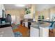 Open kitchen with stainless steel appliances, granite countertops, and breakfast bar at 121 Fitzgerald Ln, Davenport, FL 33837
