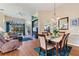 Open-concept living and dining area with hardwood floors, comfortable furnishings, and a view to the outdoors at 121 Fitzgerald Ln, Davenport, FL 33837