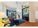 Bright living room featuring hardwood floors, stylish decor, and a cozy fireplace at 121 Fitzgerald Ln, Davenport, FL 33837