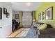 Bright living room featuring hardwood floors, a modern workstation, and a comfortable brown sofa with decorative pillows at 121 Fitzgerald Ln, Davenport, FL 33837