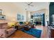 Inviting living room featuring hardwood floors, comfortable seating, and a large window at 121 Fitzgerald Ln, Davenport, FL 33837