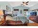 Relaxing main bedroom boasts a tray ceiling, ceiling fan, and large windows at 121 Fitzgerald Ln, Davenport, FL 33837