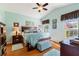 Serene main bedroom features a tray ceiling, ceiling fan, ensuite bath, and lots of natural light at 121 Fitzgerald Ln, Davenport, FL 33837