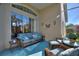 Relaxing screened patio features comfortable seating, a ceiling fan, and serene outdoor views at 121 Fitzgerald Ln, Davenport, FL 33837