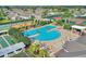 A refreshing pool with lush landscaping and plenty of lounge chairs under yellow and blue umbrellas at 121 Fitzgerald Ln, Davenport, FL 33837