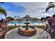 Resort-style pool with a charming fountain feature, palm trees, and inviting atmosphere for relaxation at 121 Fitzgerald Ln, Davenport, FL 33837