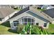 Aerial view of the home's screened lanai, lush backyard, and manicured landscaping at 121 Fitzgerald Ln, Davenport, FL 33837