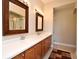 Bathroom with a double sink vanity with two large mirrors and wooden cabinetry at 1230 Wright Cir # 5309, Celebration, FL 34747