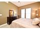 Bedroom with natural light, ceiling fan, dresser with mirror, and a comfy chair at 1230 Wright Cir # 5309, Celebration, FL 34747