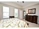 Bedroom featuring a decorative bedspread, side tables, dresser and lots of natural light at 1230 Wright Cir # 5309, Celebration, FL 34747