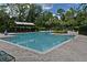 Community pool with inviting clear water surrounded by lush landscaping and lounge seating at 1230 Wright Cir # 5309, Celebration, FL 34747