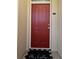Charming red front door with welcome mat, unit 309, for a cozy entrance at 1230 Wright Cir # 5309, Celebration, FL 34747