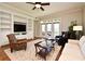 Cozy living room with hardwood floors, ceiling fan, built-in shelves, and glass doors to the patio at 1230 Wright Cir # 5309, Celebration, FL 34747